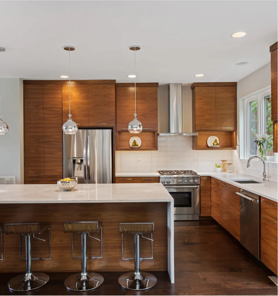 kitchen-6 Modern kitchen with wood cabinets, an island with stools, stainless steel appliances, and pendant lights.